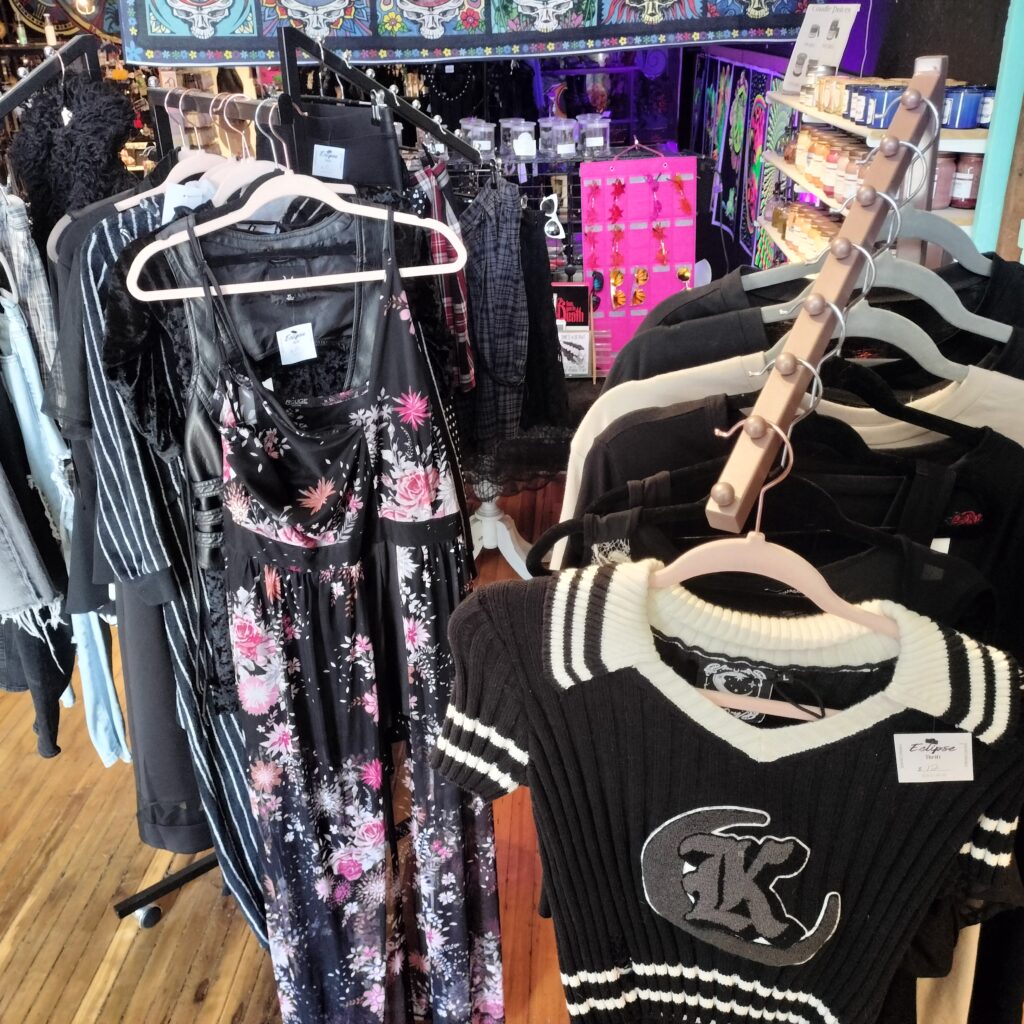 Inside a colorful downtown Brockport shop, racks of clothing and eclectic gifts